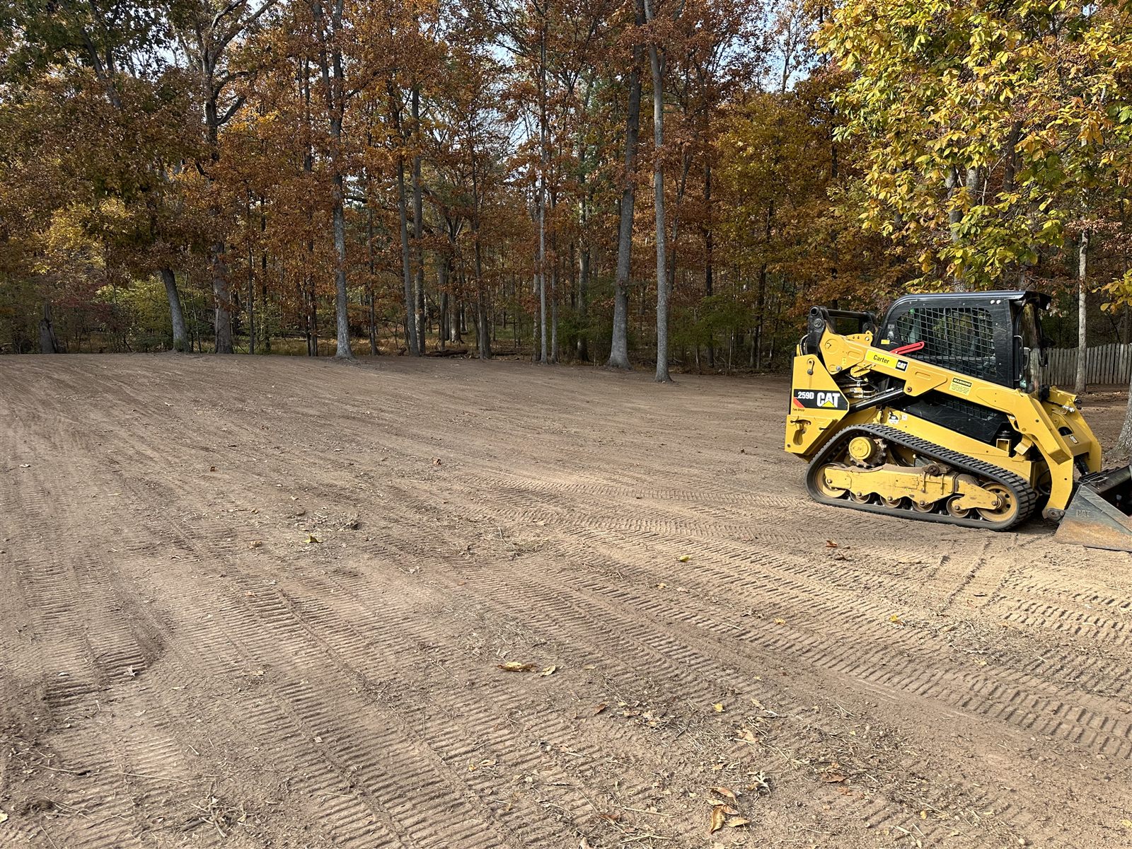 Compact track loader on a freshly graded lot cleared by MB Homestead